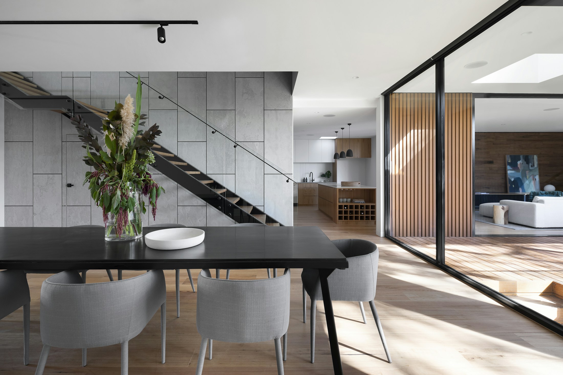 Light-filled interior opening onto a green courtyard